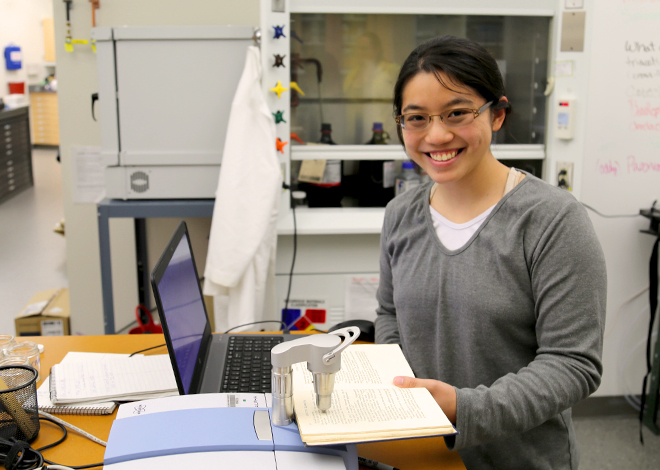 An HSC fellow uses a machine to analyze paper