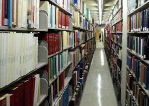 Library shelving with student in the distance