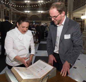 donor looking at rare book