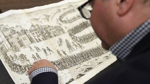 Curator Earle Havens studies a manuscript