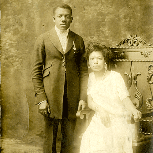 historic postcard with standing Black male and seated female