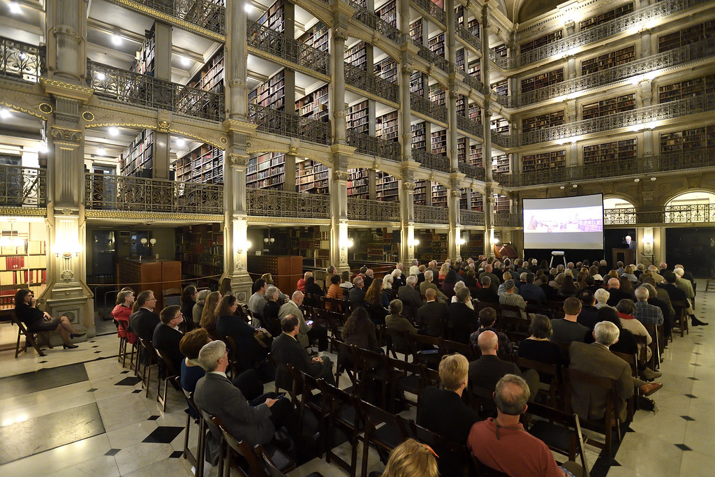 people seated at a lecture in the George Peabody Library