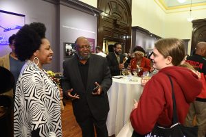 People talking at an exhibition reception