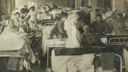 old photo of wartime hospital with soldiers in beds