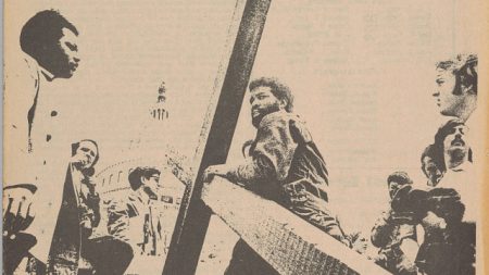 black and white photo of man carrying cross towards US Capitol Building