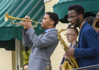 three musicians playing brass instruments