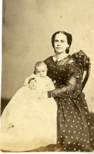 archival photo of seated woman with baby